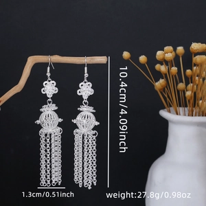Detail view of silver bohemian long tassel earrings with dimensions on a black backdrop