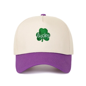 Detailed embroidery of a green clover with lucky text on a two-tone trucker cap