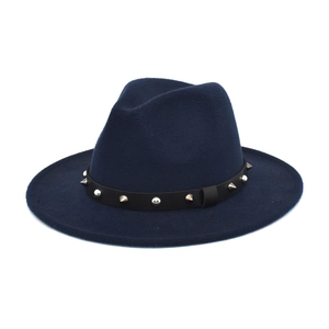 Detail of dark blue wool fedora with studded leather belt trim and wide brim design