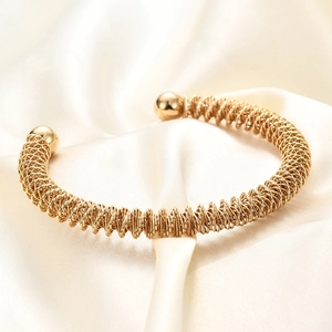Bracciale rigido a molla placcato oro 18K con sfere metalliche lucide da donna
