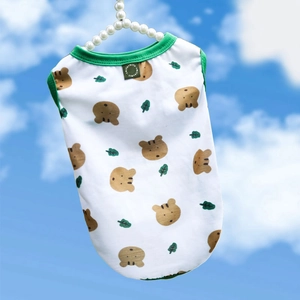Detail of white cotton pet vest with green trim and cute bear print on a pearl hanger