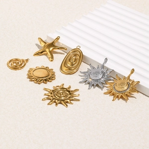 Detailed view of 18K gold plated stainless steel sun and starfish charm pendants