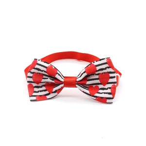 Detail of adjustable heart print dog bowtie with durable polyester webbing and buckle