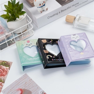 Three 3-inch mini photo albums in green black and purple with heart cut-outs