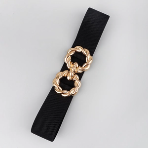 Detail of black elastic belt featuring a decorative gold twisted metal buckle closure