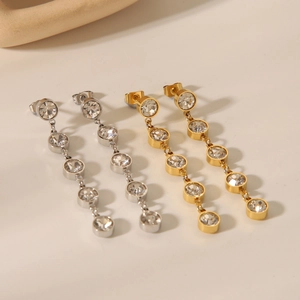 Detail view of 18K gold and silver dangling chain earrings with crystal rhinestones