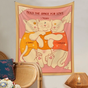 Bohemian cat tapestry with Hold The Space For Love text hanging in a cozy living room