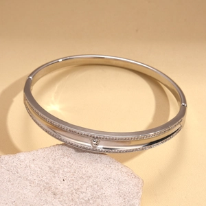 Detail of silver plated bangle with heart accent and sparkling zircon stones
