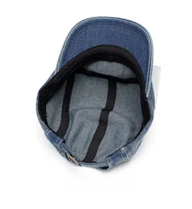 Internal view of navy denim army cap showing sweatband, stitching, and metal buckle