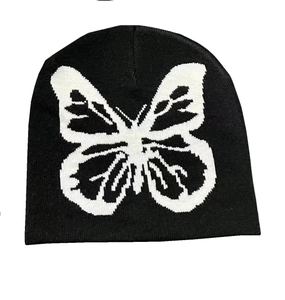 Detail of black knit beanie featuring a large white butterfly jacquard pattern