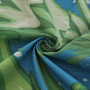 Macro shot showing breathable floral printed fabric with dense mesh texture and vibrant colors