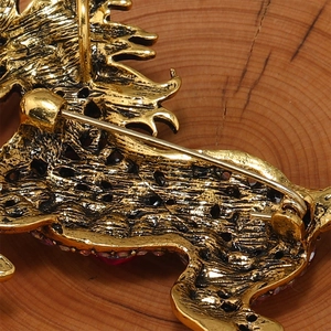 Detailed view of the golden unicorn brooch back with pin clasp and hollow metal texture