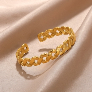 Detailed macro view of gold-plated woven texture on hollow cuff bracelet for women