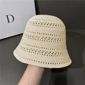 Chic hollow out crochet bucket hat in cream white featuring detailed woven textures