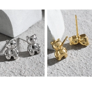 Detailed macro view of S925 sterling silver bear stud earrings showing the hallmark stamp