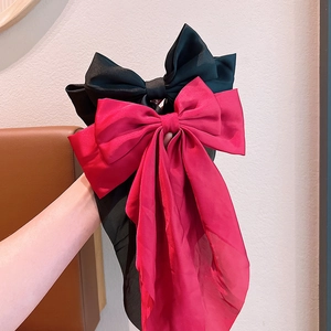 Oversized satin bow hair clips in red and black silk texture for women hairstyles