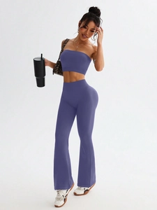 Women's violet seamless yoga set featuring a crop top and high waist flared leggings