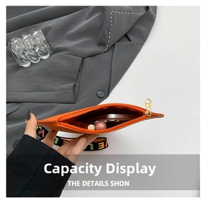 Détail de l'intérieur du mini sac orange en cœur avec rangement pour téléphone