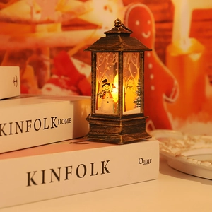 Macro detail of a vintage bronze Christmas lantern with warm LED snow scene lighting
