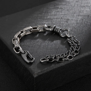 Detail of vintage steel bracelet with thick chain and double thin link splice design