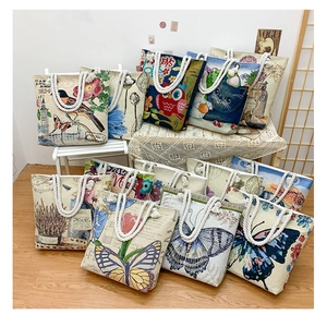 Detailed view of large canvas tote bag with floral patterns and durable cotton rope handles