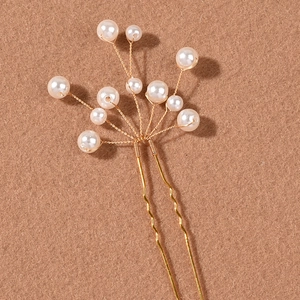 Elegant bridal hair pin with handmade pearls and gold wire branches for wedding hairstyles