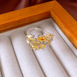 Close-up of vintage silver ring featuring pear-cut yellow zircons in a jewelry box