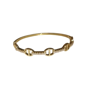 Gold plated oval bracelet with sparkling cubic zirconia in coffee bean design
