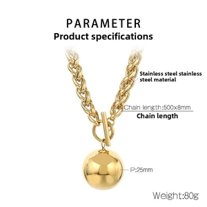 Detailed macro view of a 25mm polished gold metal ball pendant on a chunky cable chain