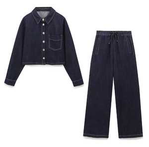 Detail of dark blue denim set with long-sleeved cropped jacket and high-waist wide pants