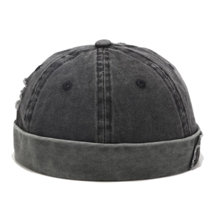 Detail of vintage grey washed denim miki hat with distressed ripped effects and roll cuff
