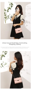 Detail of pink quilted handbag with V-shaped stitching and golden metal chain strap