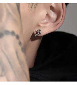 Close-up of 925 sterling silver stud earring featuring a black gothic cross design