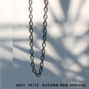 Vertical view of silver oval link chain necklace with high metallic luster and industrial style