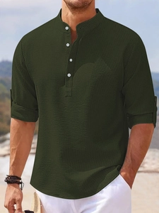 Detail of army green waffle knit texture on men's long sleeve polo shirt with buttons