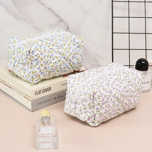 Quilted floral cosmetic bags in blue and purple styles with secure zipper closure