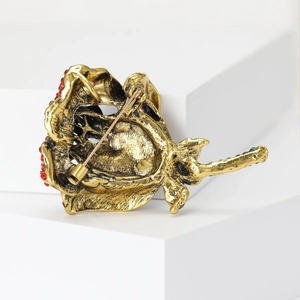 Elegant rose flower cardigan brooch in vintage gold metal with red and green rhinestones
