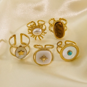 Detailed collection of 14K gold stainless steel rings with shell and tiger eye stone inlay