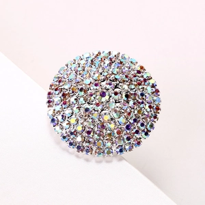 Silver geometric round ring with sparkling colorful rhinestones on a white surface