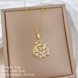 Detailed view of gold swan necklace pendant with full crystals and size specifications