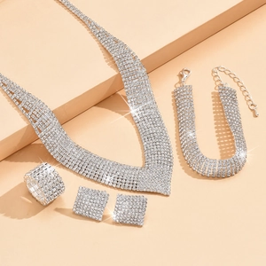 Elegant 4-piece silver bridal jewelry set with sparkling rhinestones on tiered display