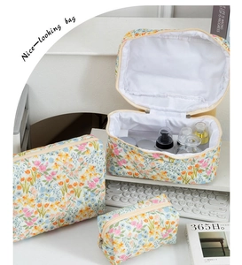 Three-piece quilted floral makeup bag set with zip closure in various sizes
