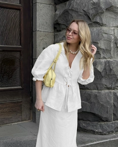 Detail of white V-neck linen set with ruffle short sleeves and tiered tie-front closure