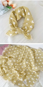 Detail of yellow cotton linen scarf featuring white hearts and delicate lace borders