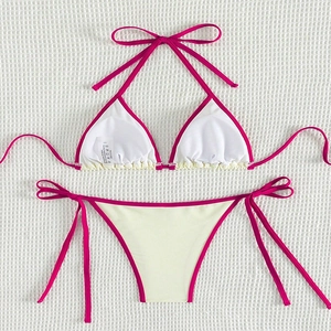 Detail of cream bikini set with hot pink trim showing adjustable side-tie bottom