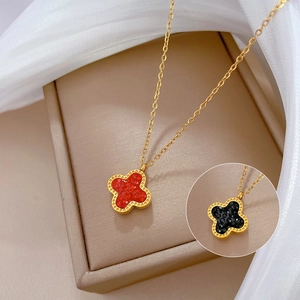 Minimalist double-sided clover necklace with red and black crystal insets in gold plating