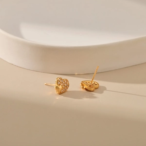 Macro shot of 18K gold plated heart earrings with sparkling cubic zirconia inlay