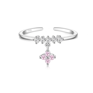 Macro view of S925 silver ring featuring pink clover pendant and sparkling white zirconias