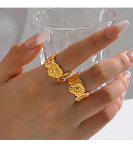 Detailed view of adjustable gold flower rings with colorful zircon inlays on model