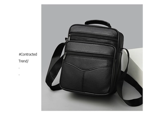 Detail view of black lychee grain leather crossbody bag with multiple zipper compartments